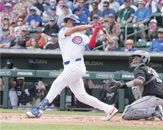  ?? JOHN ANTONOFF/SUN TIMES ?? Christophe­r Morel follows through on a home run in the first inning of the Cubs’ spring opener Friday against the White Sox at Sloan Park.