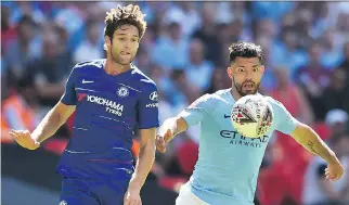  ?? GLYN KIRK/AFP/GETTY IMAGES ?? Manchester City’s Sergio Aguero, right, and Chelsea’s Marcos Alonso keep their eyes on the ball during their English FA Community Shield match on Sunday at London’s Wembley Stadium.