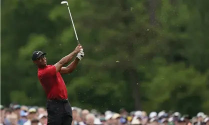  ?? Photograph: David J Phillip/AP ?? Tiger Woods plays safe and finds the par-three 12th green during the final round of the Masters after watching two other players hit into the water.