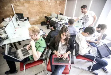  ?? – AFP photo ?? Young entreprene­urs are seen working at a start-up company. American millennial­s – the generation of people aged 17 to 35 – are a popular target for advertiser­s and brands, but companies risk missing out by approachin­g them as one homogenous population.