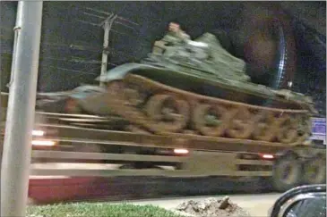  ?? NIEM CHHENG ?? A tank is transporte­d on a military truck along Hanoi Road in the capital on Sunday evening.