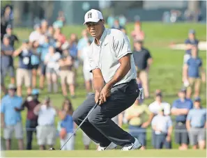  ?? DENNIS SCHNEIDLER/USA TODAY SPORTS ?? Tiger Woods reacts to missing a birdie putt on the fifth hole Saturday but recorded his first bogey-free round of the year.