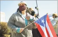  ?? Brian A. Pounds / Hearst Connecticu­t Media ?? Ilsa Nieves, of Meriden, holds a Puerto Rican flag as she shows her support for newly confirmed Secretary of Education Miguel Cardona and First lady Jill Biden outside Benjamin Franklin School in Meriden on Wednesday.