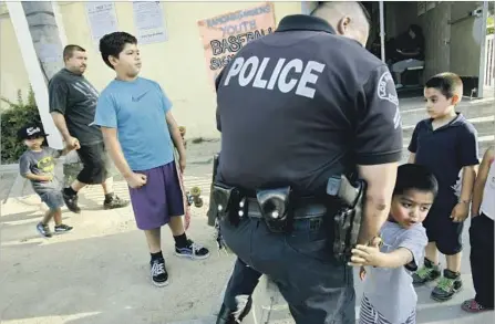  ?? Michael Robinson Chavez Los Angeles Times ?? OFFICER CLEM TOSCANO at the Ramona Gardens Recreation Center in Boyle Heights in 2014 after an apparently racially motivated firebombin­g. British researcher­s will team with the Rand Corp. in a bid to one day be able to forecast prejudice-motivated...