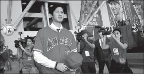  ?? AP/JAE C. HONG ?? Shohei Ohtani stands outside Angel Stadium in Anaheim, Calif., on Saturday after agreeing to join the Los Angeles Angels on a minor league contract with a signing bonus of $2,315,000. Angels Manager Mike Scioscia said Wednesday that the team knew...