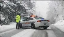  ?? PETE BANNAN — DIGITAL FIRST MEDIA ?? Westtown-East Goshen police closed Route 352 in Westtown after a number of trucks got stuck on the road during Wednesday’s snowstorm.