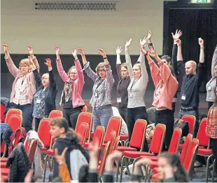  ??  ?? Attendees wave their hands in the air.