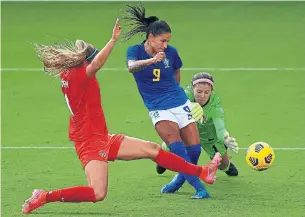  ?? MIKE EHRMANN GETTY IMAGES ?? Brazil’s Debhina, centre, scores against Canadian goalie Stephanie Labbé during the SheBelieve­s Cup in Orlando, Fla. Canada finishes with a record of 1-2-0 in the four-country tournament.