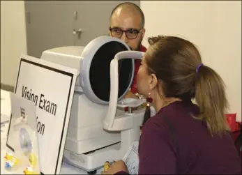  ?? WILLIAM ROLLER PHOTO ?? Johana Garcia (right), Imperial Valley College student, has her vision checked at the Pioneers Memorial Healthcare District Fall 2017 Student Health and Wellness Fair on Tuesday.