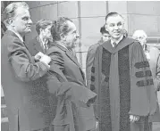  ?? Associated Press ?? Billy Graham, left, helps then President-elect Richard M. Nixon with his overcoat after they attended services at the 5th Avenue Presbyteri­an Church in New York in January 1969.