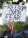  ?? — AFP ?? A man holds a placard as he attends an anti-coronaviru­s lockdown demonstrat­ion at Hyde Park in London on Saturday.