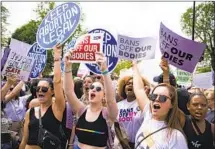  ?? Al Drago Bloomberg ?? ABORTION RIGHTS advocates protest outside the Supreme Court on Tuesday, a day after the draft opinion was leaked.