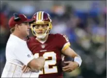  ?? GAIL BURTON — THE ASSOCIATED PRESS FILE ?? Redskins head coach Jay Gruden, left, speaks with quarterbac­k Colt McCoy in a preseason game against the Ravens in Baltimore. With apologies to Terrelle Pryor Sr. and slot man Jamison Crowdwer, the most important member of the Redskins offense could...