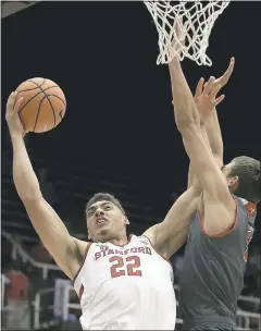  ?? BEN MARGOT — THE ASSOCIATED PRESS ?? Stanford’s Reid Travis goes hard to the basket against Eastern Washington’s Mason Peatling during Tuesday’s game. The Cardinal lost 67-61.