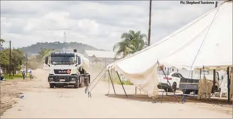  ??  ?? Pic: Shepherd Tozvireva
A truck occupies the opposite lane after Foodicon, a food and beverage manufactur­er, pitched a tent at the centre of Conald Road in Granitesid­e industrial area in Harare