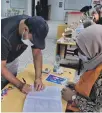  ?? ?? A Libyan man registers to vote in the elections at a polling station in Tripoli