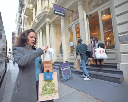  ?? JENNIFER S. ALTMAN/FOR USA TODAY ?? Christina Cobb shows one of her purchases during a recent day of shopping in New York City. When it comes to buying gifts, she says, “I always seek out the least-toxic and most eco-friendly options.”