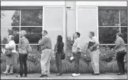  ??  ?? Dozens of people line up Wednesday to seek a job at the Wells Fargo call center in Salem, Ore.