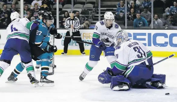  ?? AP PHOTO/MARCIO JOSE SANCHEZ ?? Vancouver Canucks goaltender Anders Nilsson is beaten for a goal on a shot from the Sharks’ Brent Burns, not seen, on Thursday in San Jose, Calif.