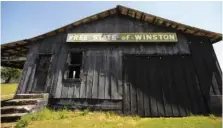  ?? AP PHOTO/JAY REEVES ?? An abandoned building adorned with the age-old nickname of Winston County, stands Monday near Double Springs, Ala. The county, which tried to secede from Alabama at the start of the Civil War, is trying to get more people immunized but running into problems with both supply and public willingnes­s.