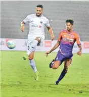  ?? PIC/PTI ?? Players of North East United FC (White Jersey) play against FC Pune City (Purple-orange jersey) during the ISL football match at Indira Gandhi Athletic Stadium in Guwahati on Wednesday