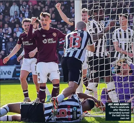  ?? ?? JOY AND AGONY: Hearts celebrate after Mandron (grounded) turned the ball into his own net