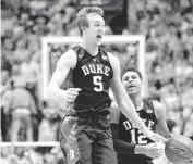  ??  ?? Duke’s Luke Kennard, left, and Derryck Thornton celebrate after defeating North Carolina 74-73 on Wednesday.