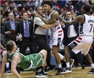  ?? Washington Post file photo ?? Kelly Oubre (center) was suspended for Game 4 after bowling over Kelly Olynyk Thursday.