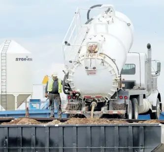  ?? TED RHODES/CALGARY HERALD FILES ?? A truck unloads material at the Tervita Treatment Recovery Disposal operation in Alexander, N.D. Tervita is selling its service rig business while trying to renegotiat­e a $2.5-billion debt.