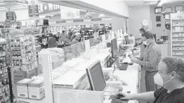  ?? PAUL RATJE/THE NEW YORK TIMES ?? Workers fill prescripti­ons at a grocery store pharmacy Aug. 19 in Albuquerqu­e, New Mexico. Health care costs continue to climb across the country.