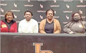  ?? Scott Herpst ?? Dr. Sarah Cannon, Kelly Anderson and Nautica Johnson joined Lafayette players, coaches and administra­tion to watch senior running back Jamario Clements sign on to continue his football playing career at Duquesne University last week.