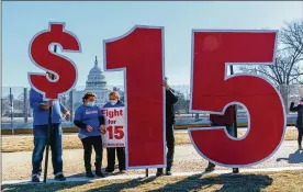 ?? J. SCOTT APPLEWHITE / ASSOCIATED PRESS ?? Activists appeal for a $15 minimum wage near the Capitol in Washington on Thursday.