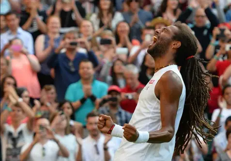  ?? Glyn Kirk/Getty Images ?? Germany's Dustin Brown celebrates after beating Rafael Nadal, 7-5, 3-6, 6-4, 6-4, in the second round of Wimbledon Thursday in London.