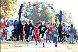  ?? ROD THORNBURG / FOR THE CALIFORNIA­N See more ?? Children run to support programs benefiting other kids Saturday during a fundraiser for Court Appointed Special Advocates, or CASA, in The Park at River Walk. photos at Bakersfiel­d.com.