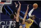  ?? SUE OGROCKI — THE ASSOCIATED PRESS ?? Lakers forward LeBron James, right, shoots as Oklahoma City Thunder forward Isaiah Roby (22) and forward Darius Bazley defend during the first half on Wednesday.