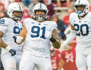  ?? DOUG MCSCHOOLER/AP ?? Penn State defensive tackle Dvon Ellies, center, and 12 others from Maryland will wave the banner for Penn State on Saturday when they host the Maryland Terrapins.