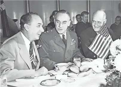  ?? THE COMMERCIAL APPEAL FILES ?? Top-ranking visitors attending the Victory Day luncheon at The Peabody on 11 Nov 1952 were Vice Adm. Felix B. Stump (Right), commander of the Second Fleet and luncheon speaker, and Maj. Gen. Robert W. Douglass Jr. (Center), commander of the 18th Air Force, who were greeted by Judge Carl Stokes, chairman of the American Legion's luncheon committee.