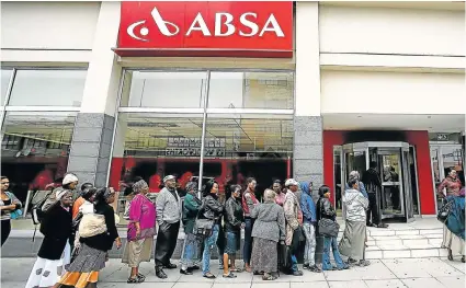  ?? Picture: MARK ANDREWS ?? TANGLED LIFELINE: Dozens of people wait outside an Absa branch in East London to be paid social grants. Absa subsidiary AllPay has contested a decision by Sassa to award the contract for running the welfare payment system to a rival