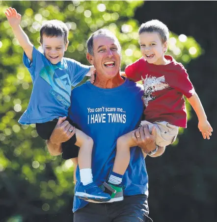  ??  ?? Stay-at-home dad Dayne Grimmond with his 4-year-old twin sons Ryan and Elliot at Mudgeeraba. Picture: ADAM HEAD