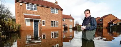  ??  ?? Catastroph­e: The floods in Snaith, East Yorkshire, have added to a sense of abandonmen­t