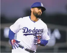  ?? Harry How / Getty Images ?? Matt Kemp rounds the bases after his solo home run against the Giants on Friday. He is appealing his one-game suspension.