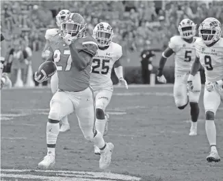  ?? AP PHOTO/JOHN RAOUX ?? Colorado State defenders trail Florida running back Dameon Pierce during a 68-yard touchdown run in the second half of Saturday’s game in Gainesvill­e, Fla. Florida won 48-10.