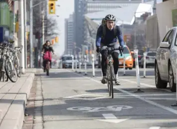  ?? BERNARD WEIL/TORONTO STAR FILE PHOTO ?? Local councillor­s Joe Cressy and Mike Layton say Bloor bike lane pilot project has been a success.