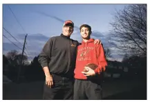  ??  ?? Larry DeLuca and his son, L.J. DeLuca, at their home in Cos Cob. L.J. played linebacker on Greenwich High School’s 2018 undefeated team, and his father played defensive end on the 1983 undefeated team.