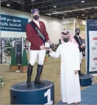  ??  ?? Omar Al Mannai, Event Director, Longines Hathab, awards Open Class winner Khalid Mohammed Al Emadi.