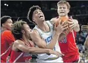  ?? Jayne Kamin-Oncea Getty Images ?? UCLA’S CHRIS SMITH fights for the ball between Arizona’s Zeke Nnaji, left, and Stone Gettings.