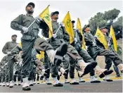  ??  ?? Hizbollah fighters parade during the inaugurati­on of a new cemetery for their fighters who died in fighting against Israel, in a southern suburb of Beirut