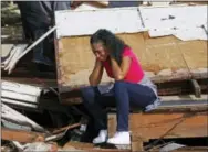  ?? ROGELIO V. SOLIS — THE ASSOCIATED PRESS ?? Shanise McMorris grieves on the slab of her Hattiesbur­g, Miss., home after an early tornado hit the city, Saturday. The tornado was part of a wall of stormy weather traveling across the region, bringing with it rain and unstable conditions.