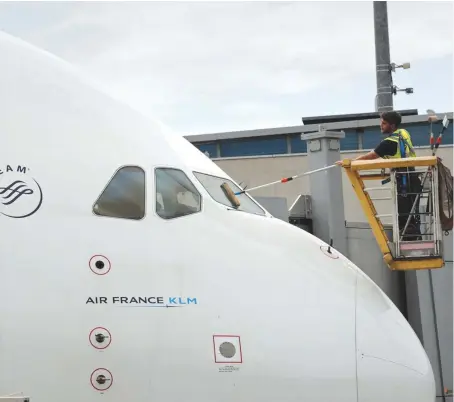  ?? Reuters ?? A worker cleans the windshield of an Air France-KLM plane at the Paris Charles de Gaulle Airport in Roissy, France, June 19, 2019.