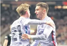  ?? — AFP photo ?? Torres (right) celebrates scoring the 1-1 equaliser with his Barcelona teammate Frenkie De Jong.